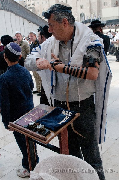 20100408_104622 D300.jpg - Jewish man putting on Tefilllon